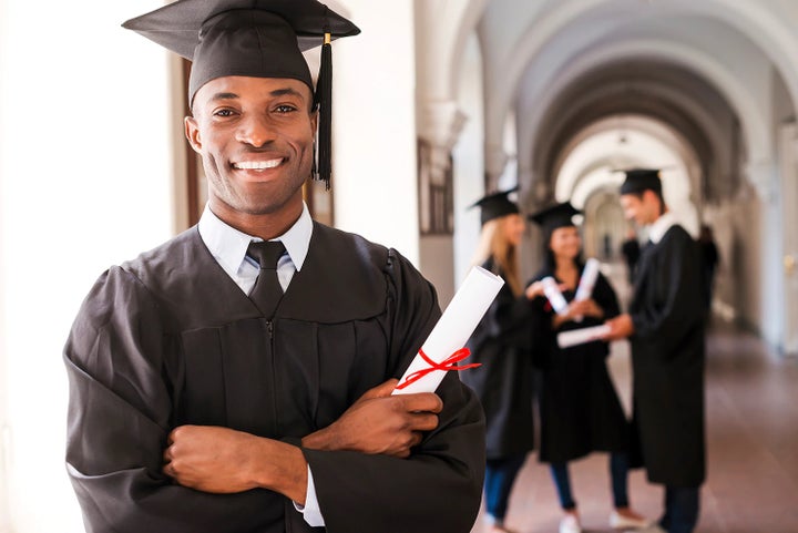 college graduate holding his diploma | Crown Subaru of Wheeling in Triadelphia WV